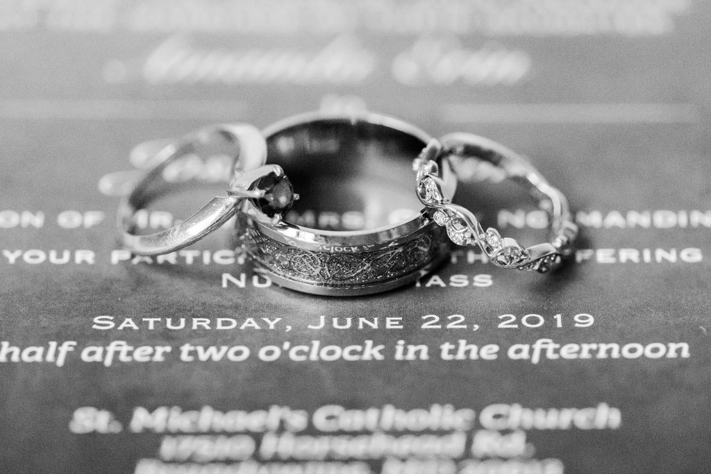 three wedding bands on invitation by costola photography