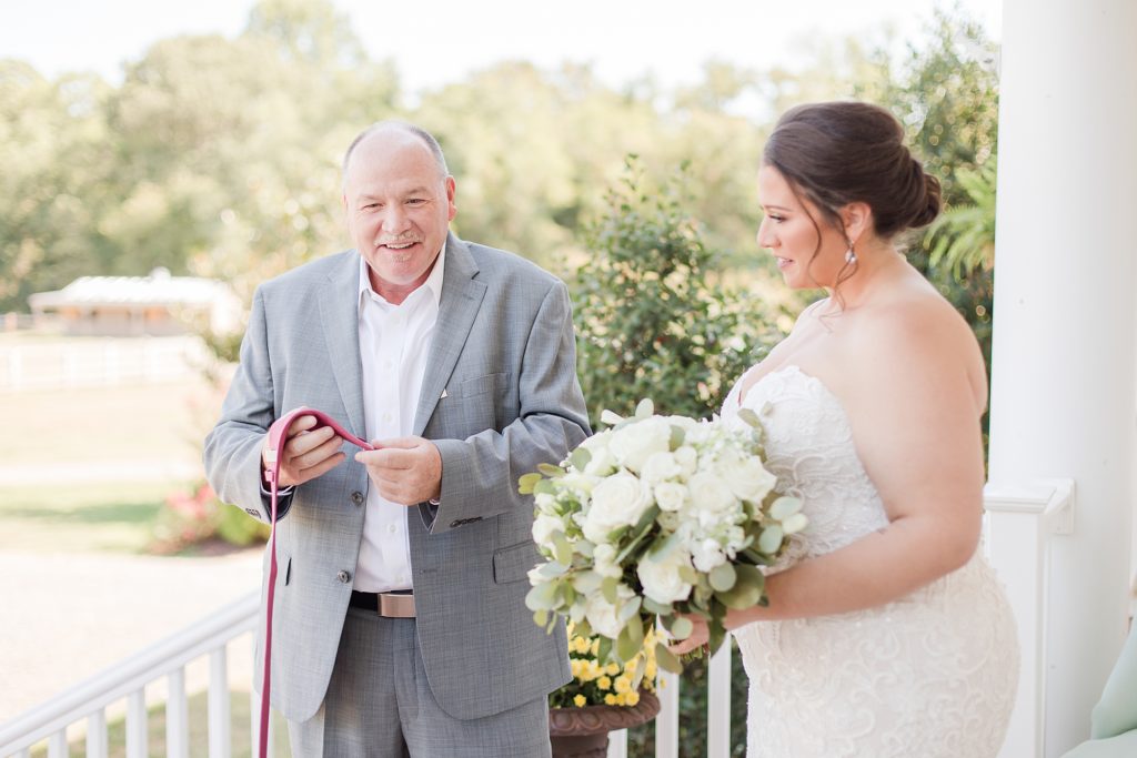 bride giving gift to dad at waterfront weatherly farm wedding by Costola Photography