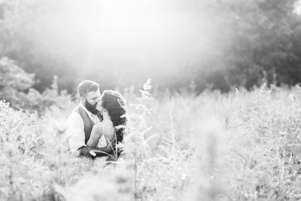 Bride and Groom kissing in field in classic Tennessee wedding by Costola Photography