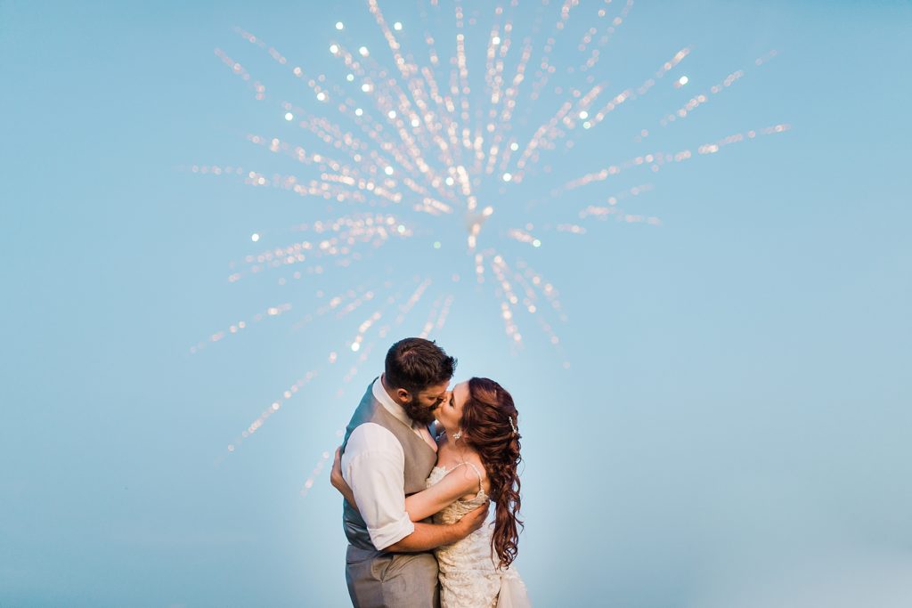 Bride and Groom Kissing with Fireworks at The Homeplace At Johnston Farm by Costola Photography