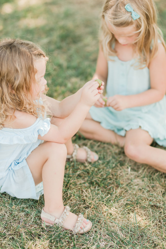 Girls playing in the grass at Playful Beach Family Session in Southern Maryland by Costola Photography