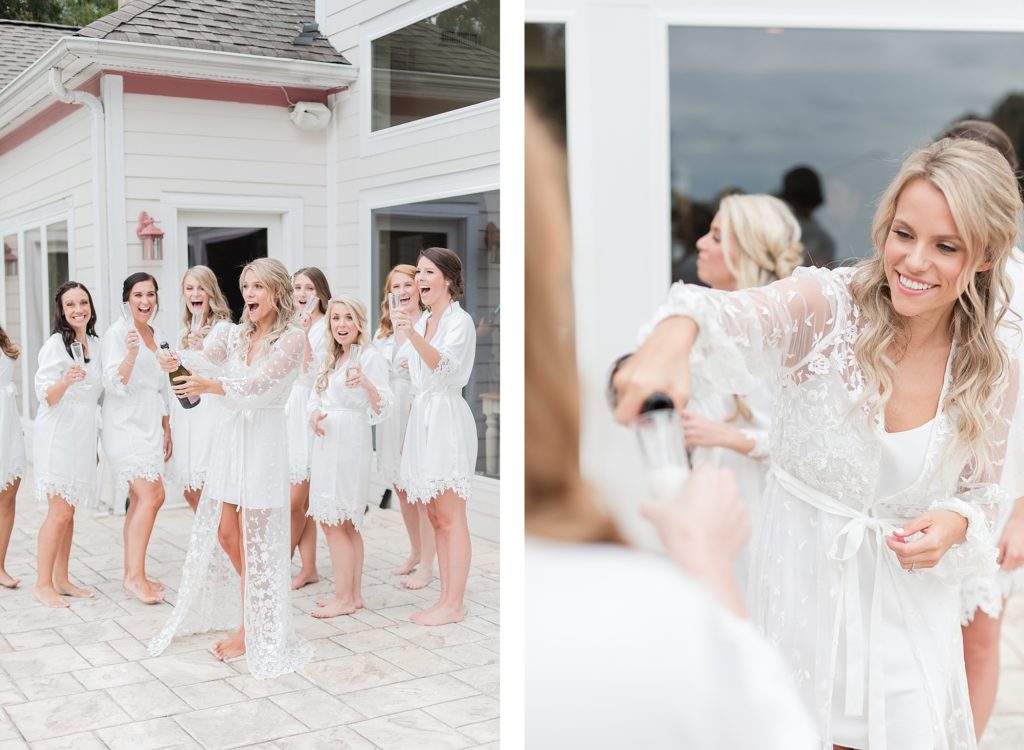 popping champagne all white bridesmaids robes at southern wedding by Costola Photography