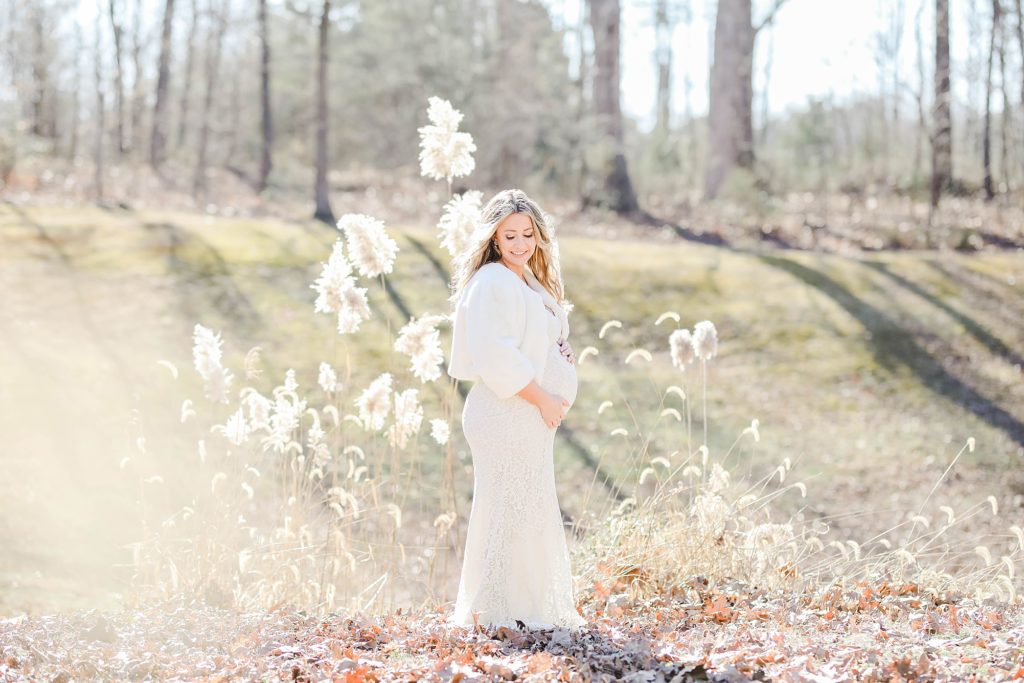 maternity session in the winter wearing a white gown in the woods by costola photography