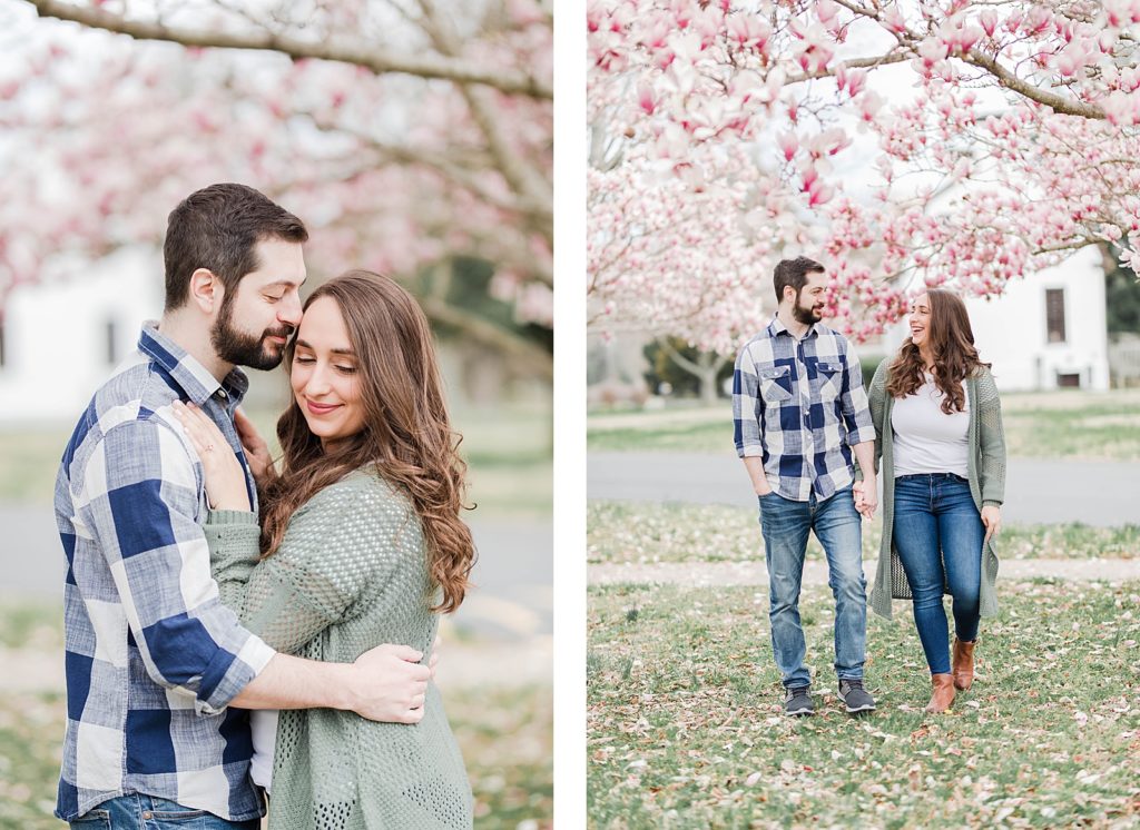 Couple standing under cherry blossom blooms in southern maryland for engagement session by Costola Photography