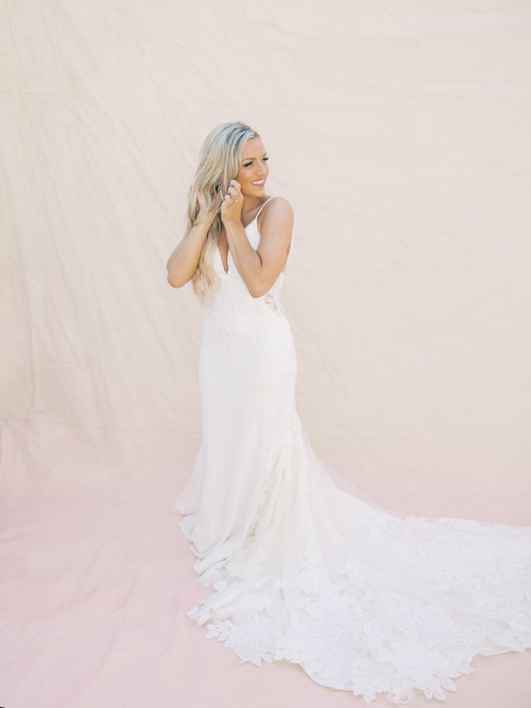 a beautiful bride wearing a white wedding dress for a flattering photo